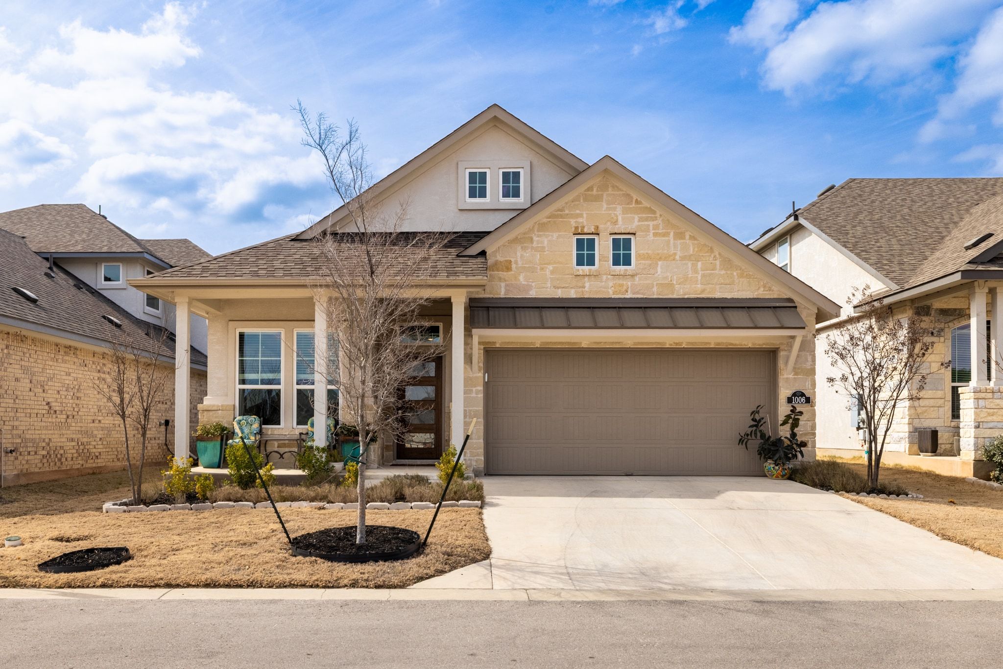 1006 Summer Glen Georgetown, TX 78628 - Photo 2 of 40 Front exterior of this Water Oak single-story home featuring an inviting front porch and professional landscaping