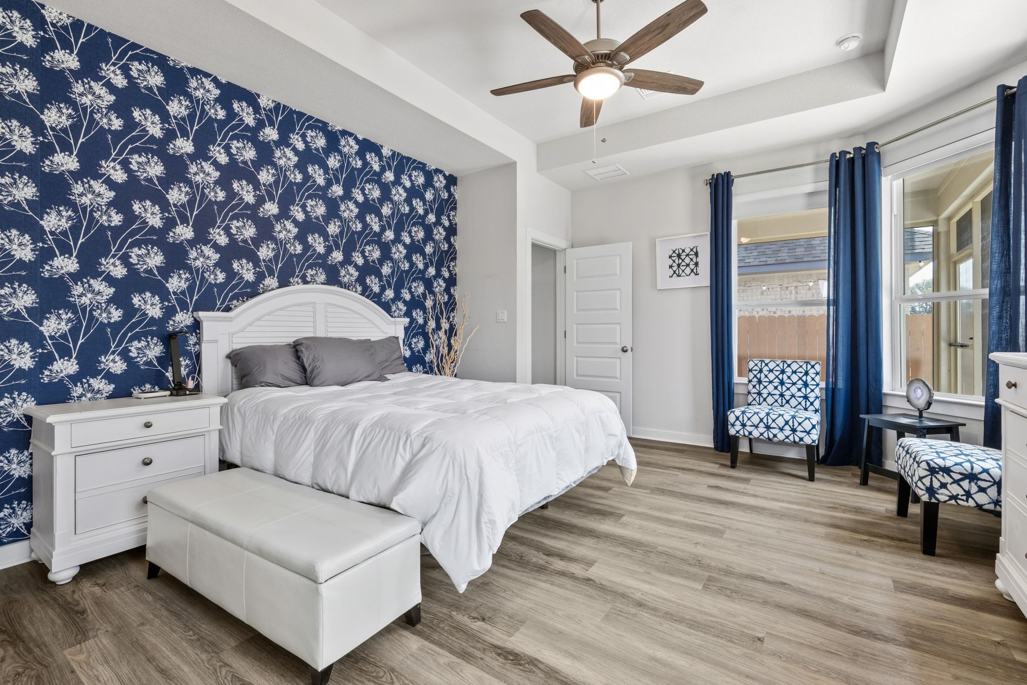 1006 Summer Glen Georgetown, TX 78628 - Photo 22 of 40 The private primary suite features a tray ceiling and wrap-around windows that provide natural light and views of the landscaped backyard