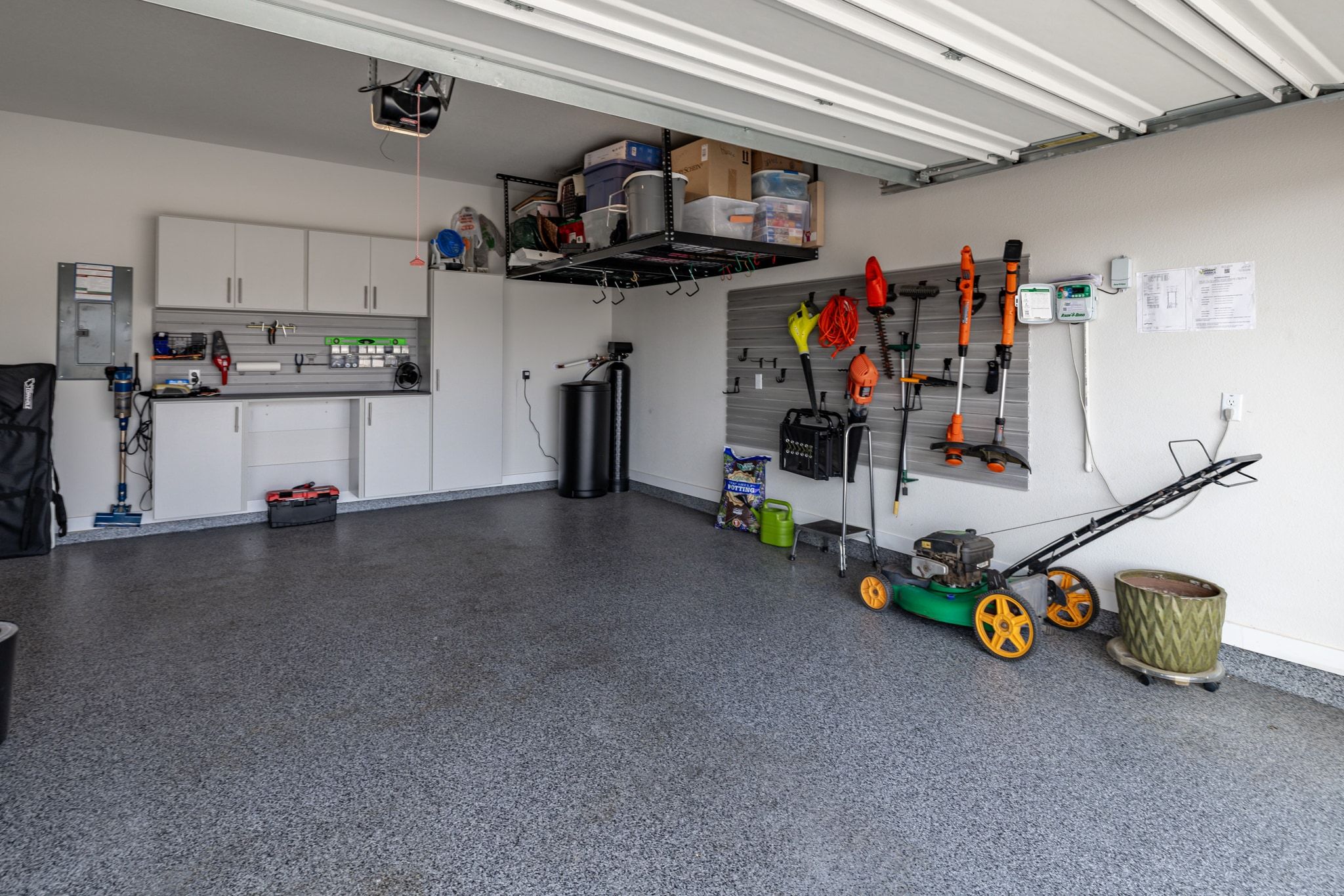 1006 Summer Glen Georgetown, TX 78628 - Photo 28 of 40 The two-car garage features a professional polyaspartic floor coating along with extensive built-in storage, including wall cabinets, a countertop workspace, and overhead racks