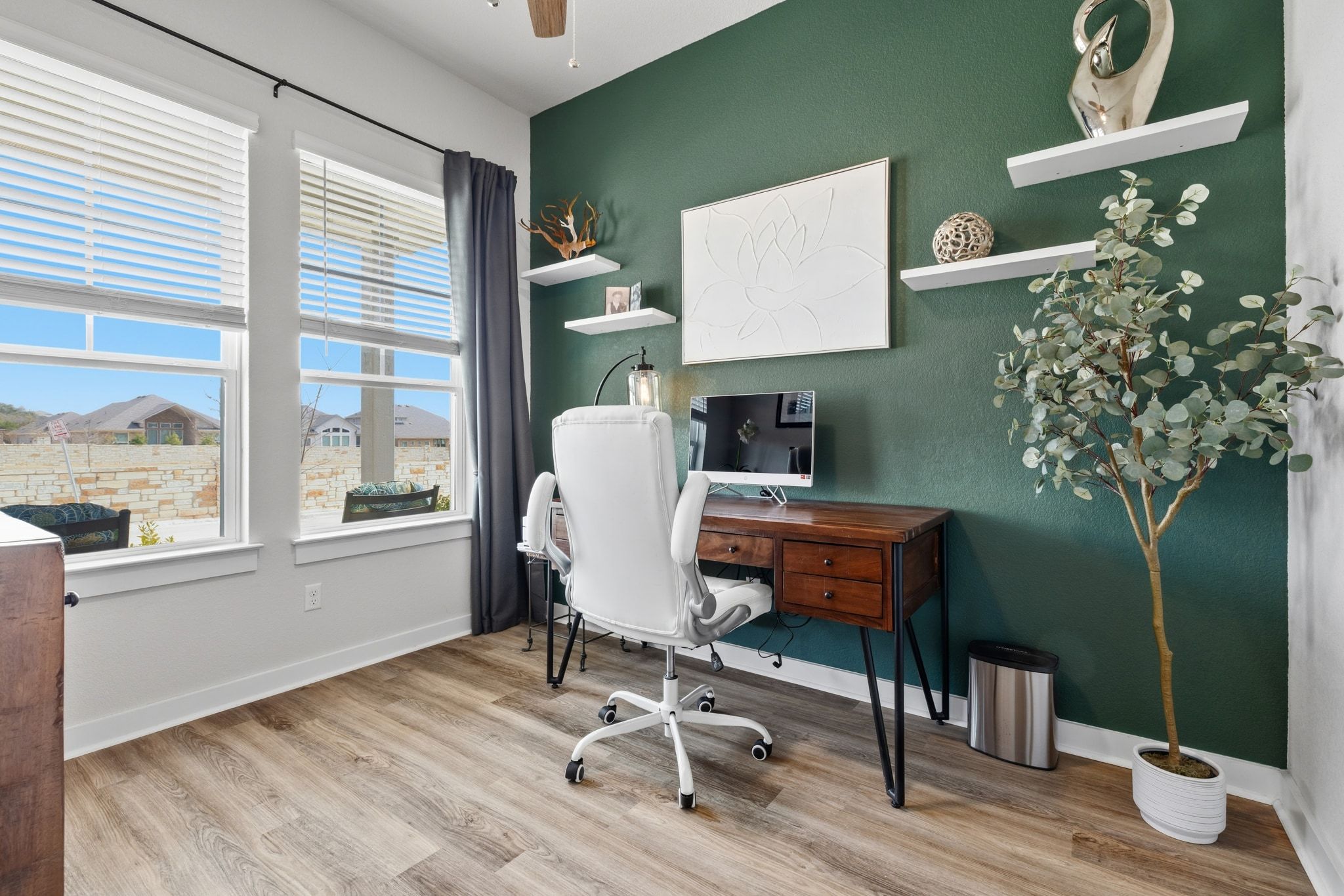 1006 Summer Glen Georgetown, TX 78628 - Photo 9 of 40 Dedicated office at the front of the home featuring an accent wall and vinyl plank flooring, providing a quiet spot for a work-from-home setup