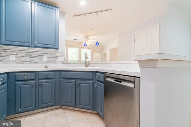a kitchen with granite countertop cabinets sink and white appliances