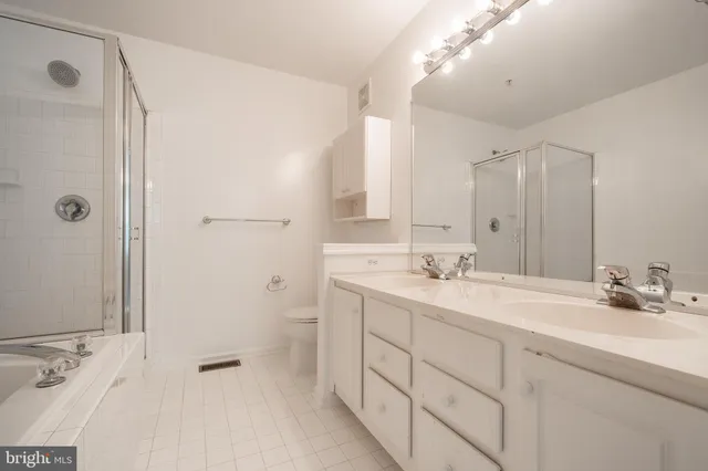 a bathroom with a double vanity sink mirror and double