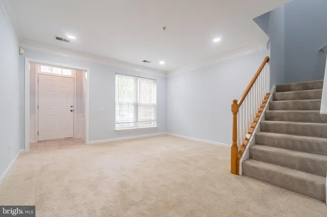 a view of an empty room with stairs