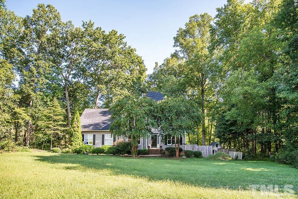 150 Shannon Road Timberlake, NC 27583 - Photo 2 of 30 a view of a big house with a big yard and large trees