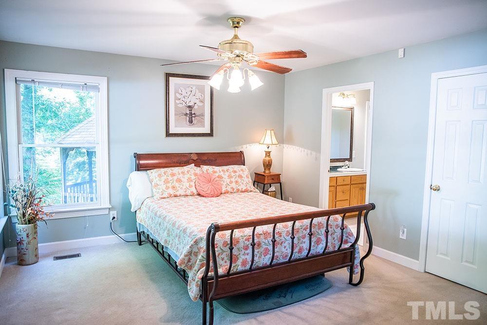 150 Shannon Road Timberlake, NC 27583 - Photo 15 of 30 a bedroom with a bed and a chandelier