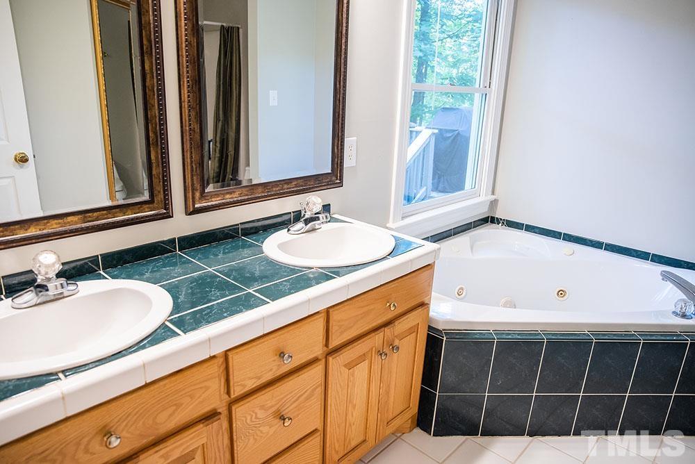 150 Shannon Road Timberlake, NC 27583 - Photo 16 of 30 a bathroom with a sink and a mirror