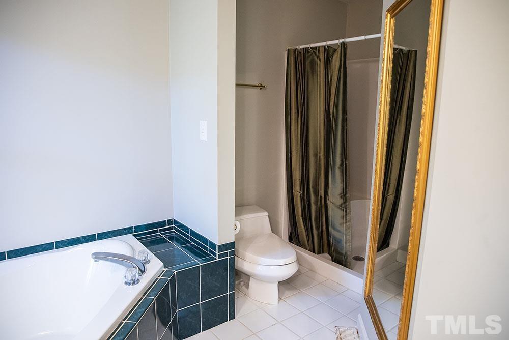 150 Shannon Road Timberlake, NC 27583 - Photo 17 of 30 a bathroom with a granite countertop sink toilet and shower
