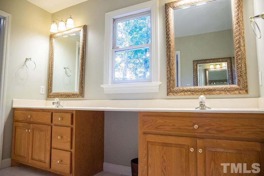 150 Shannon Road Timberlake, NC 27583 - Photo 20 of 30 a bathroom with a sink and a mirror