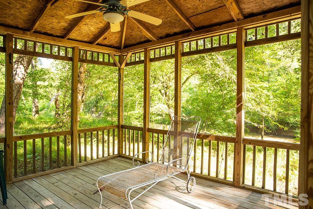 150 Shannon Road Timberlake, NC 27583 - Photo 28 of 30 a bedroom with a bed and wooden floor