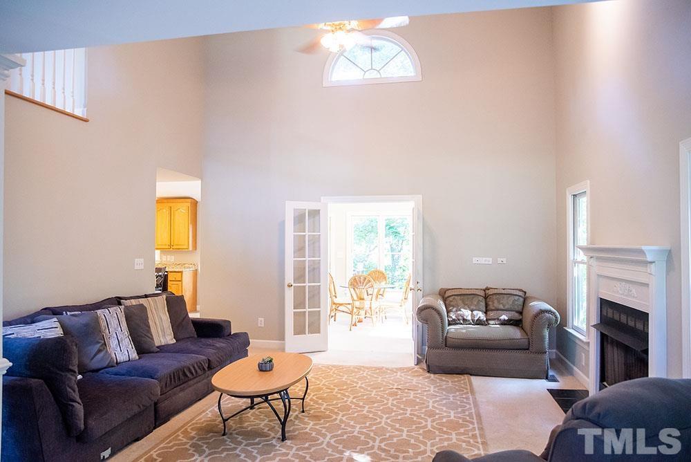 150 Shannon Road Timberlake, NC 27583 - Photo 6 of 30 a living room with furniture a fireplace and a flat screen tv
