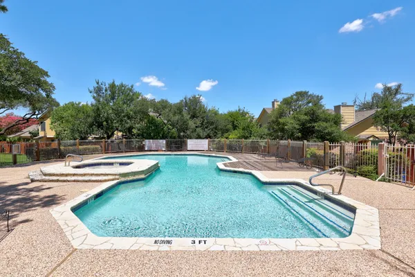 a view of a swimming pool with a lounge chair