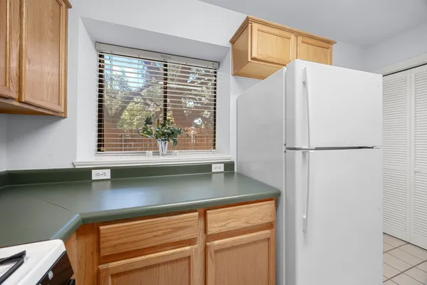 a kitchen with a refrigerator and a sink