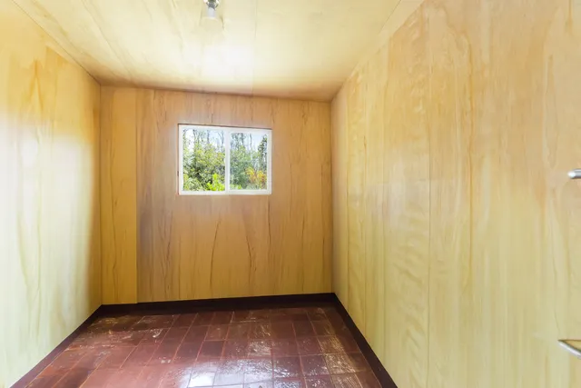a view of room with window and wooden floor