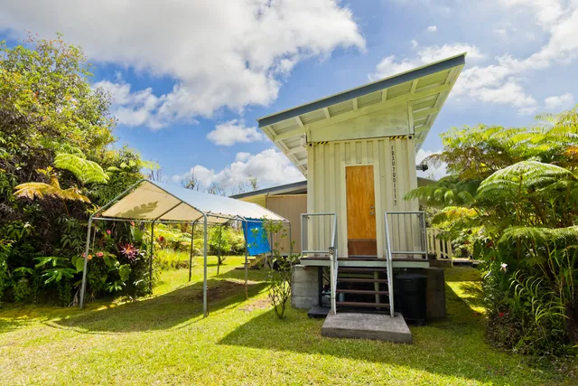 a front view of house with a garden