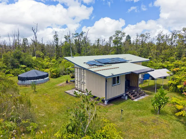 a view of a backyard with sitting area