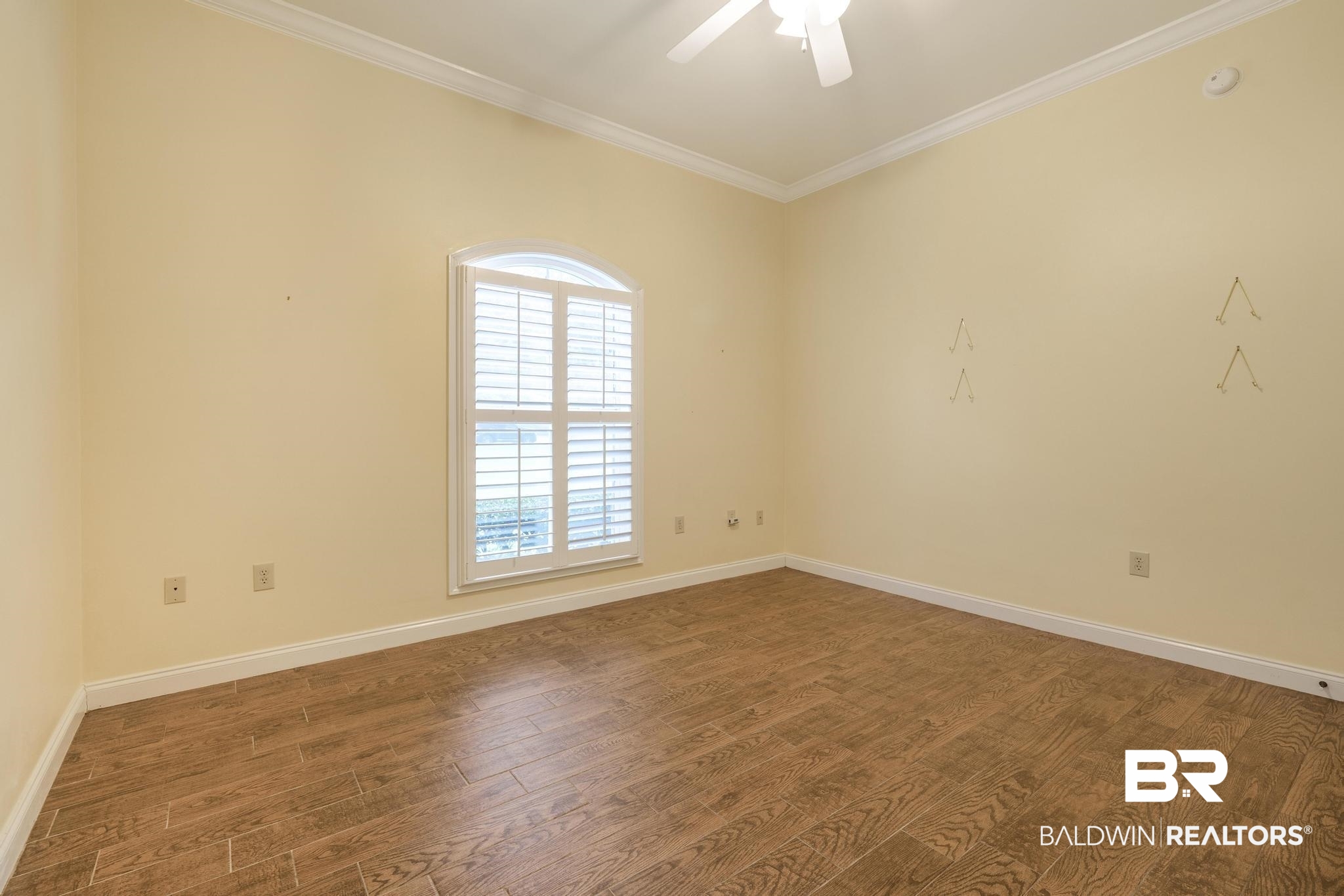 13612 Rue Royal Lane Silverhill, AL 36576 - Photo 34 of 65 Unfurnished room featuring crown molding, wood finished floors, and a ceiling fan