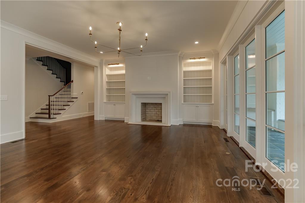 1429 Audubon Road Charlotte, NC 28211 - Photo 19 of 48 an empty room with wooden floor and fireplace