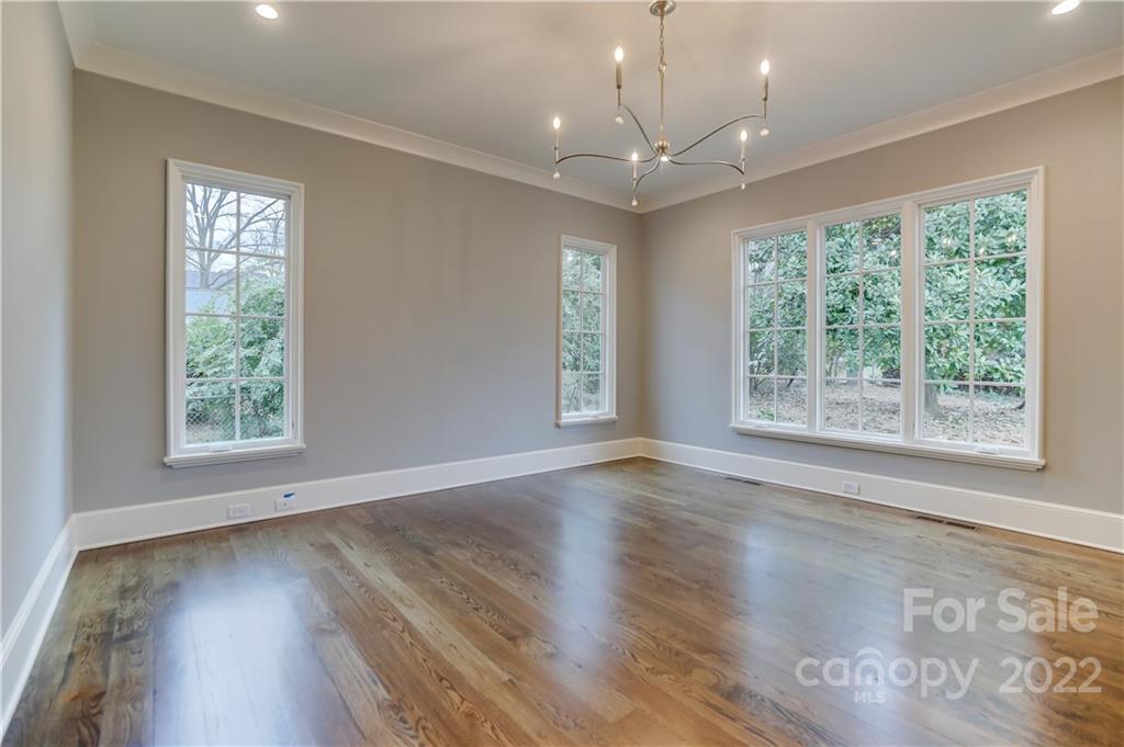 1429 Audubon Road Charlotte, NC 28211 - Photo 22 of 48 an empty room with wooden floor and windows