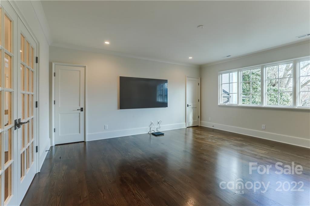 1429 Audubon Road Charlotte, NC 28211 - Photo 29 of 48 an empty room with wooden floor and windows