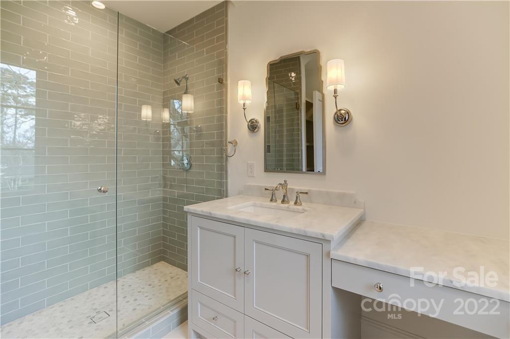 1429 Audubon Road Charlotte, NC 28211 - Photo 31 of 48 a bathroom with a shower sink and mirror