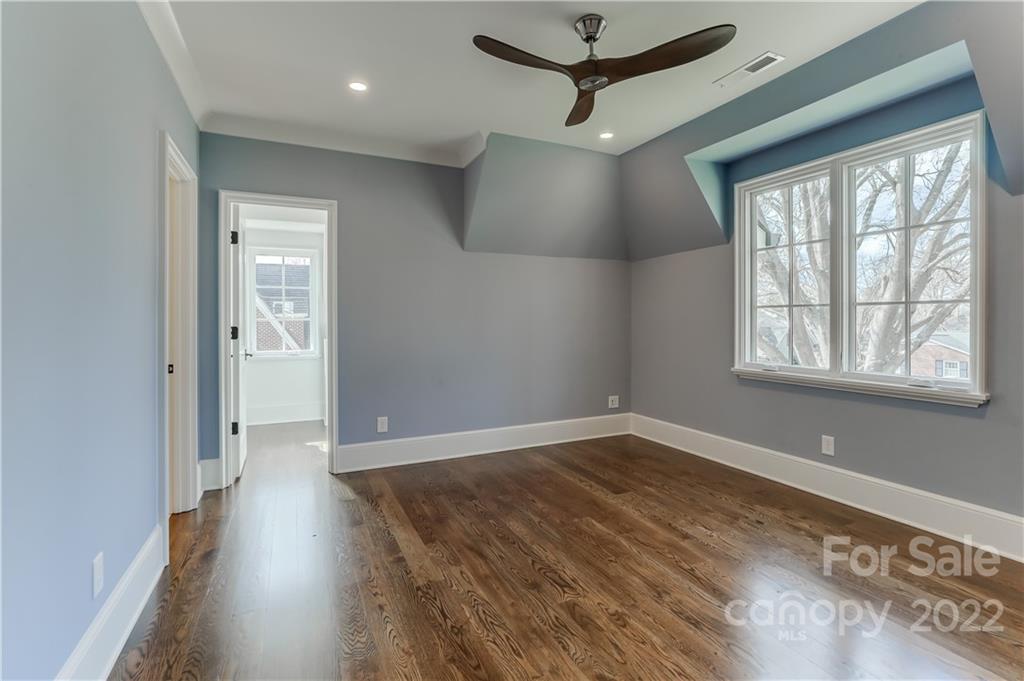 1429 Audubon Road Charlotte, NC 28211 - Photo 32 of 48 a view of an empty room with a window and wooden floor