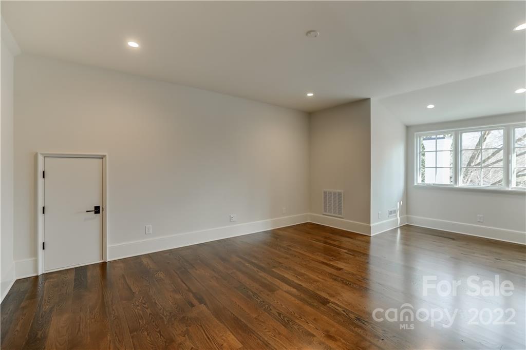 1429 Audubon Road Charlotte, NC 28211 - Photo 40 of 48 an empty room with wooden floor and windows