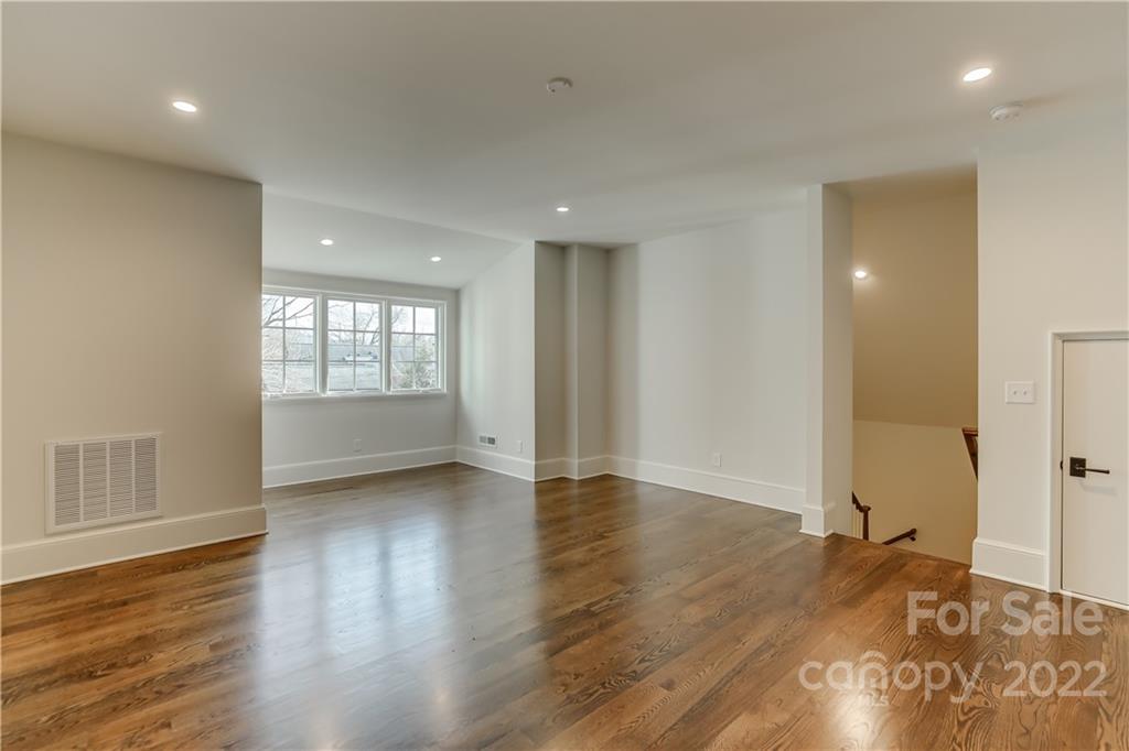1429 Audubon Road Charlotte, NC 28211 - Photo 41 of 48 a view of an empty room with wooden floor and a window