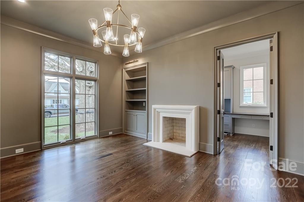 1429 Audubon Road Charlotte, NC 28211 - Photo 5 of 48 an empty room with wooden floor fireplace and windows