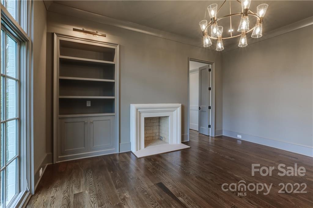1429 Audubon Road Charlotte, NC 28211 - Photo 6 of 48 a view of an empty room with wooden floor fireplace and a window