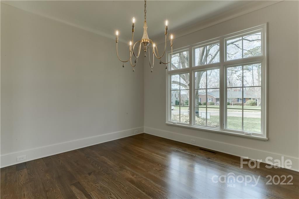 1429 Audubon Road Charlotte, NC 28211 - Photo 8 of 48 an empty room with wooden floor and windows