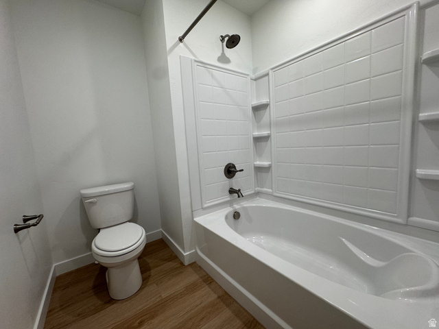 1472 North 1875 West, Unit 151 Layton, UT 84041 - Photo 17 of 20 Crisp white bathtub and shower surround with integrated shelving, complemented by oil-rubbed bronze fixtures