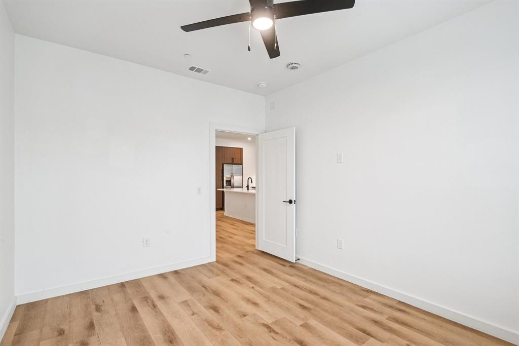2016 South Ervay Street, Unit A1 Dallas, TX 75215 - Photo 13 of 35 Spare room featuring light wood-style floors and ceiling fan
