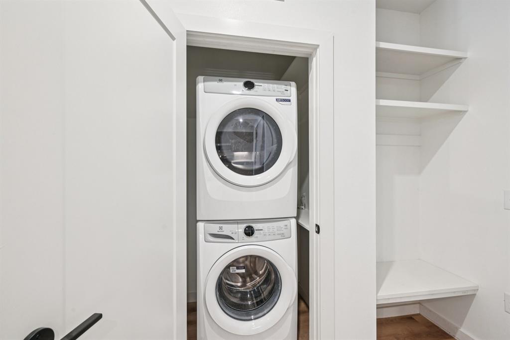 2016 South Ervay Street, Unit A1 Dallas, TX 75215 - Photo 14 of 35 Washroom featuring stacked washer / drying machine and wood finished floors