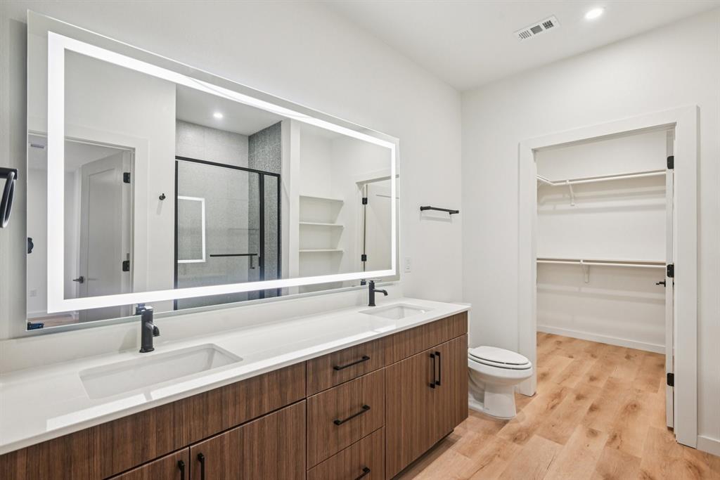 2016 South Ervay Street, Unit A1 Dallas, TX 75215 - Photo 18 of 35 Full bath featuring a spacious closet, a shower stall, double vanity, light wood-type flooring, and recessed lighting