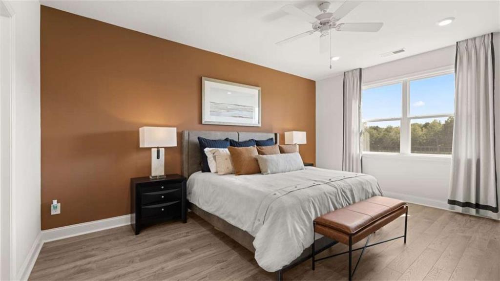 652 Parnassus Road Locust Grove, GA 30248 - Photo 21 of 43 a bedroom with a bed and wooden floor