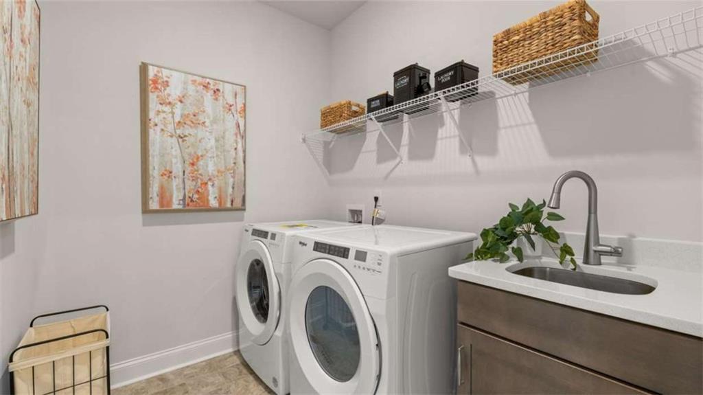 652 Parnassus Road Locust Grove, GA 30248 - Photo 29 of 43 a utility room with sink dryer and washer