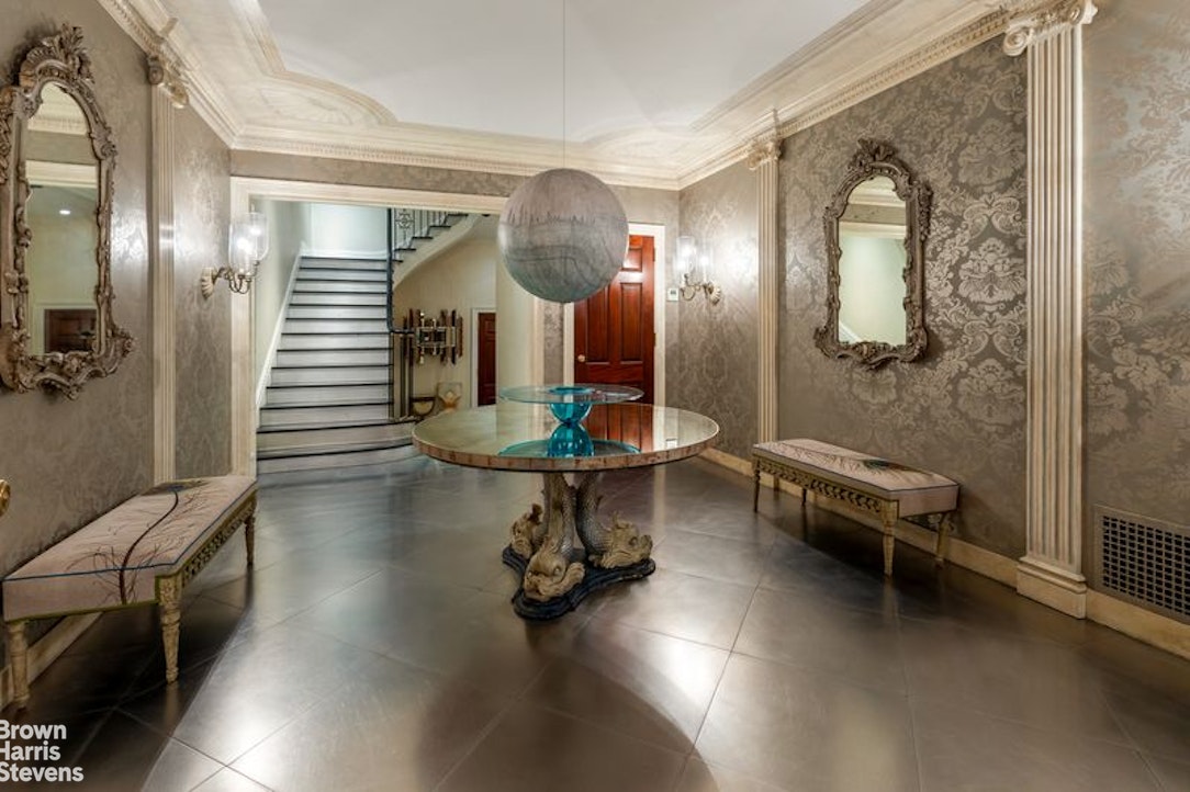 109 East 69th Street Manhattan, NY 10021 - Photo 2 of 9 a living room with furniture and a chandelier