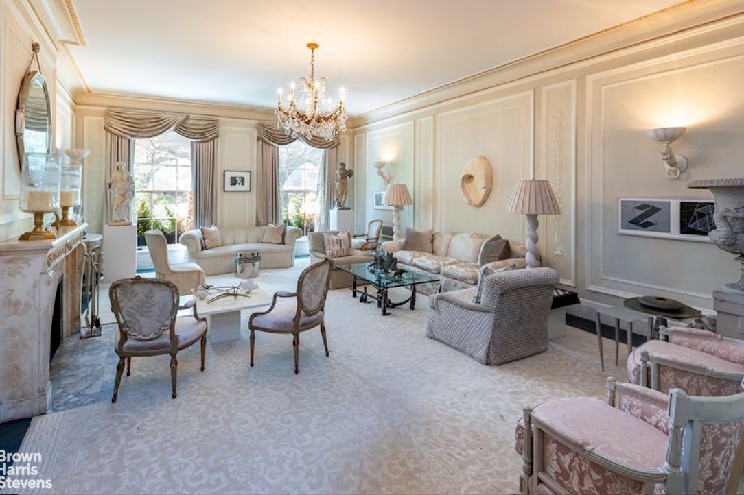 109 East 69th Street Manhattan, NY 10021 - Photo 3 of 9 a living room with furniture a chandelier and a large window