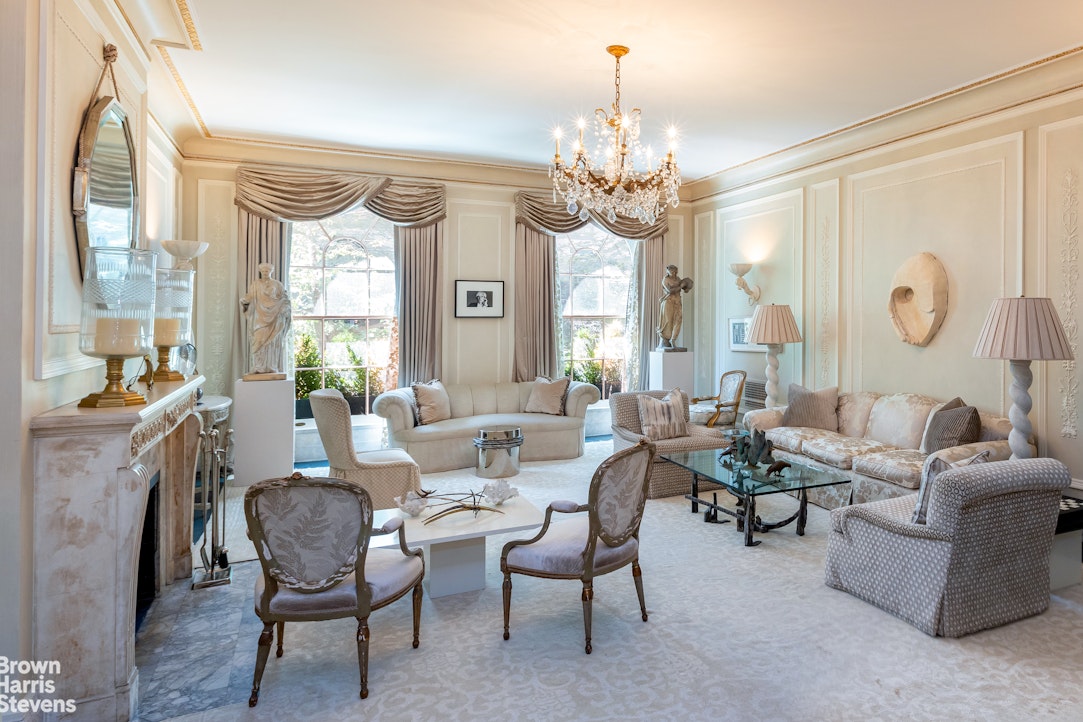 109 East 69th Street Manhattan, NY 10021 - Photo 7 of 9 a living room with furniture and a chandelier