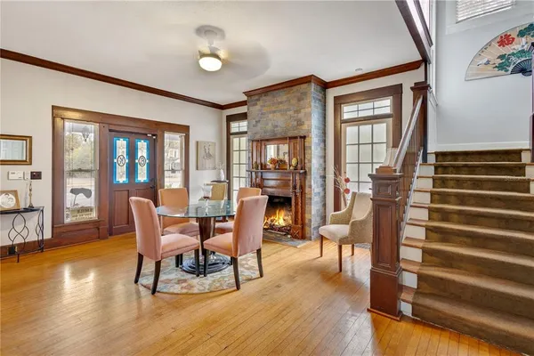 a dining room with furniture a chandelier and wooden floor
