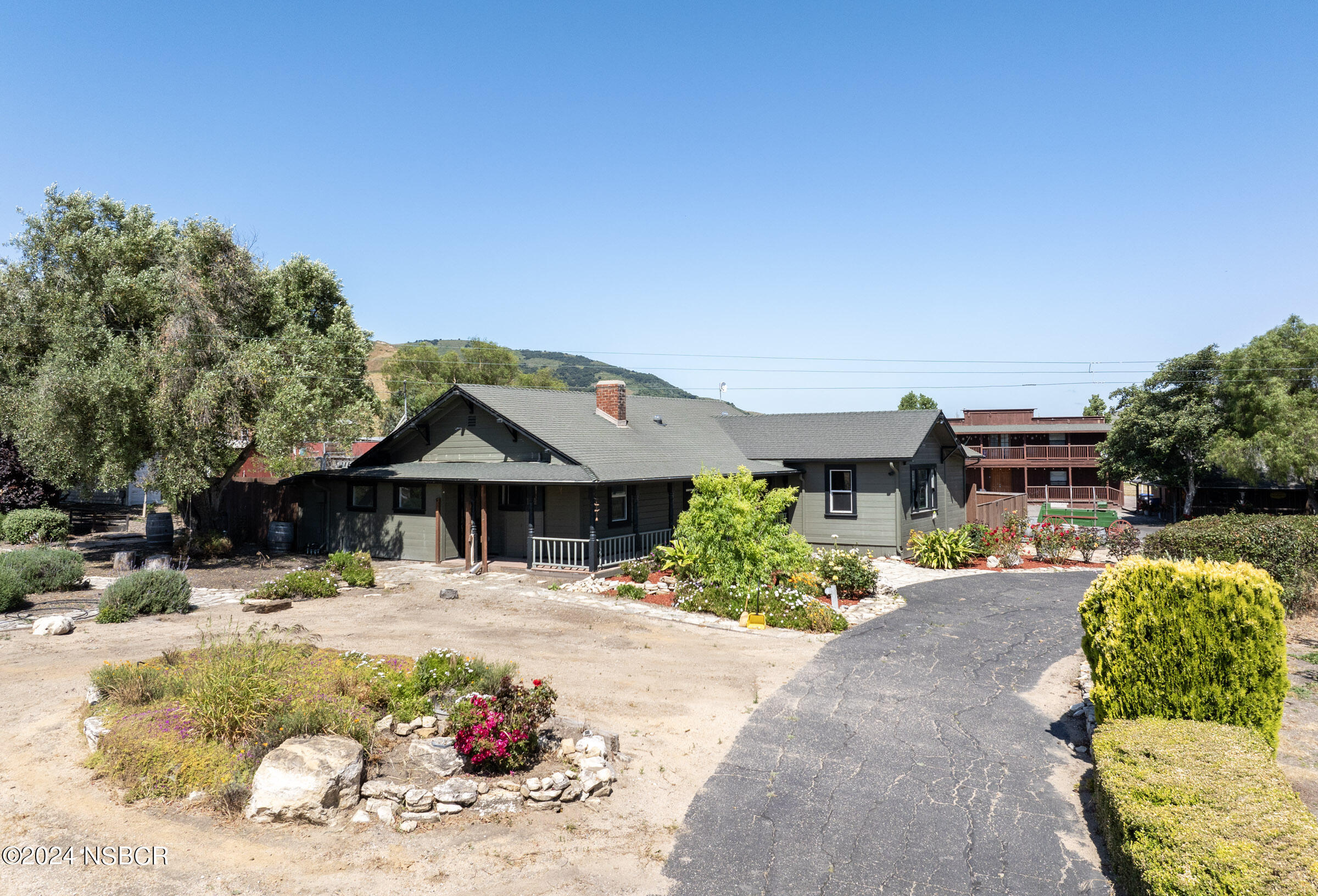 6500 Santa Rosa Road Buellton, CA 93427 - Photo 69 of 97 a patio with a table and chairs under an umbrella