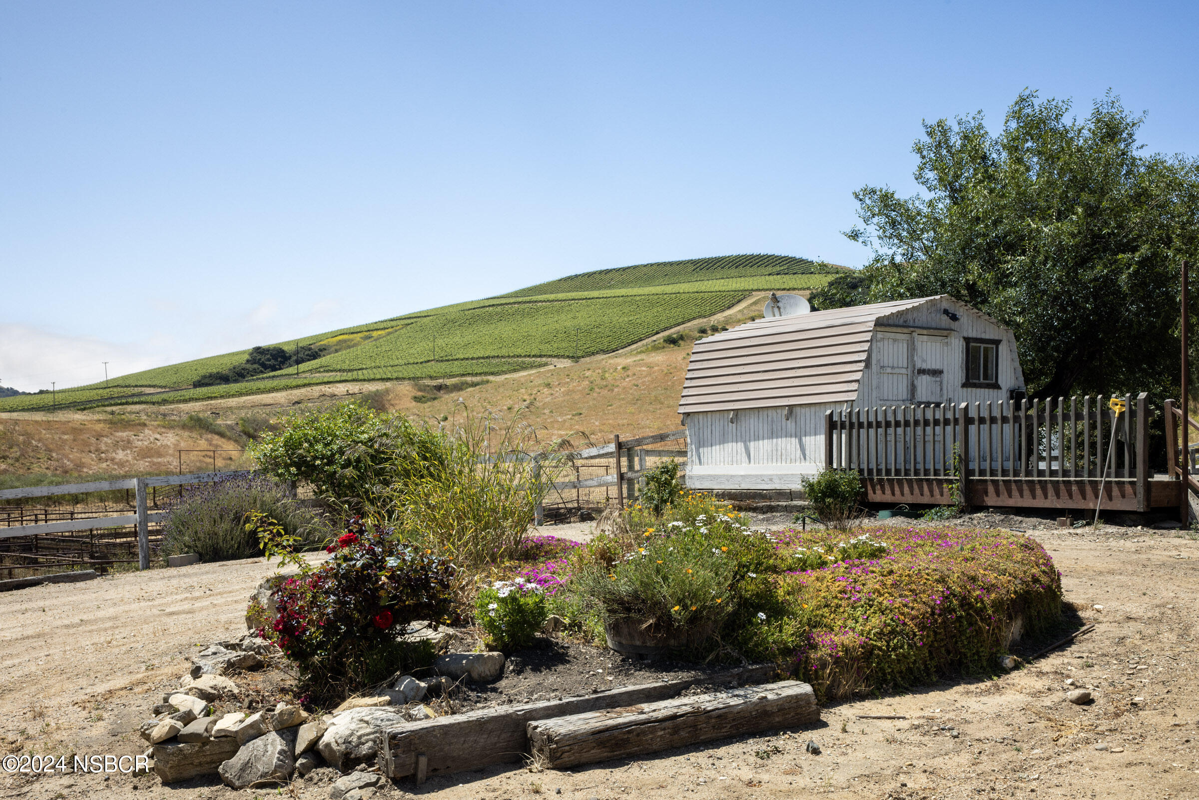 6500 Santa Rosa Road Buellton, CA 93427 - Photo 88 of 97 a view of a house with a flower garden