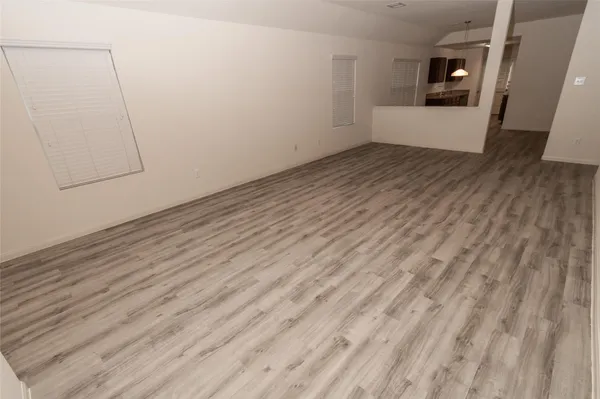 a view of a room with wooden floor