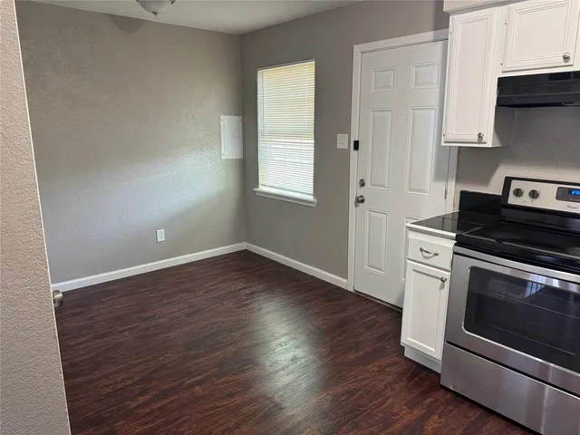 a kitchen with wooden floors and appliances