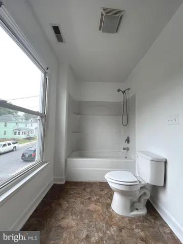 a bathroom with a toilet sink and shower