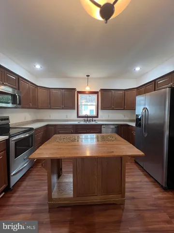 a large kitchen with wooden floor
