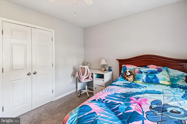 a bedroom with a bed and dresser