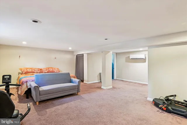 a bedroom with a bed and a couch