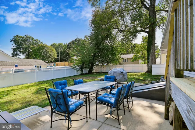 an outdoor sitting area with furniture and garden