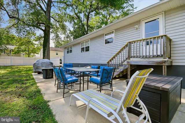 a view of a patio with a table and chairs